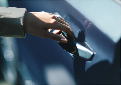A hand gracefully grips the Light Touch Handle of a 2023 Lincoln Aviator® SUV to demonstrate its ease of use
