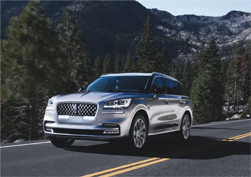 A 2023 Lincoln Aviator® Grand Touring SUV being driven on a winding road to demonstrate the capabilities of all-wheel drive | Holmes Tuttle Lincoln in Tucson AZ