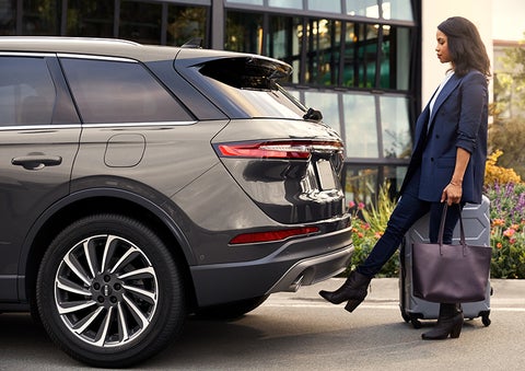 A woman with her hands full uses her foot to activate the available hands-free liftgate. | Holmes Tuttle Lincoln in Tucson AZ